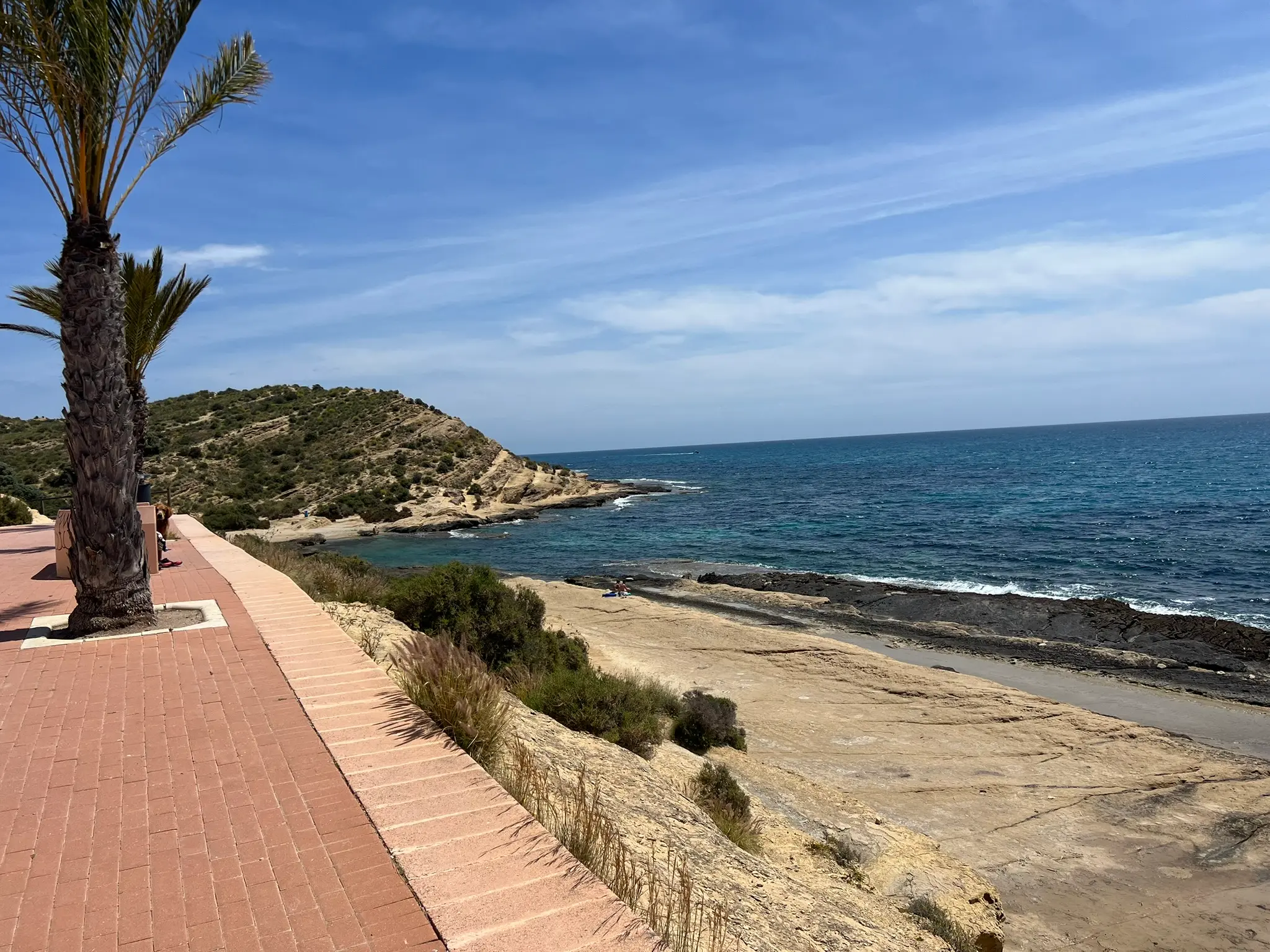 Cala Cantalar Alicante — elevated view of the secluded rocky cove at Cabo de las Huertas from seafront promenade, natural swimming spot with turquoise water