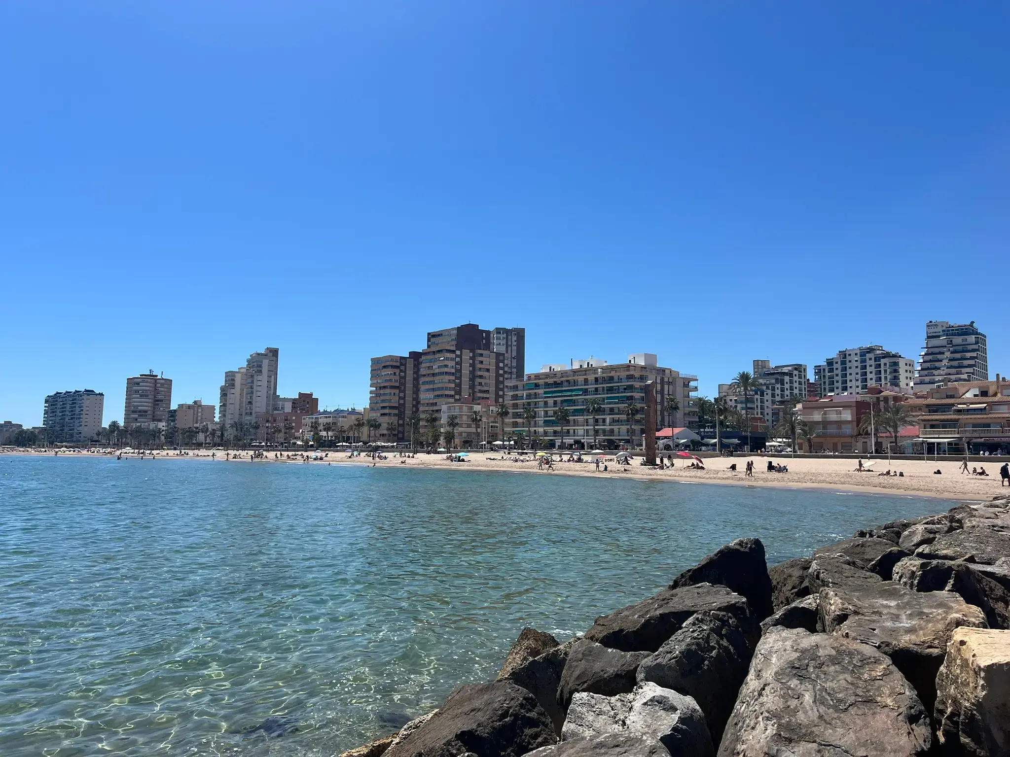 El Campello wide sandy beach with coastal skyline of high-rise hotels and Mediterranean sea, Alicante