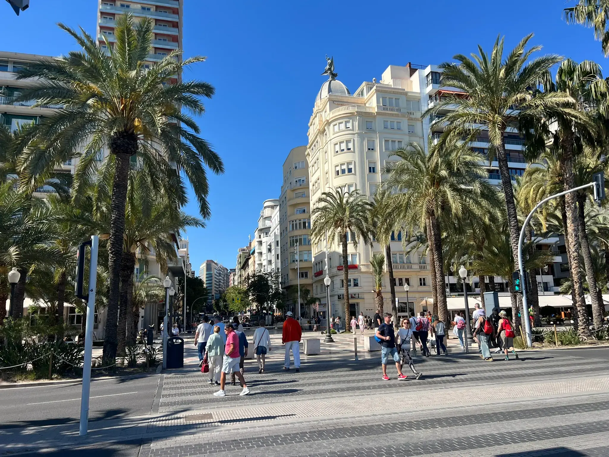 Pedestrian crossing on the Explanada de España with Casa Carbonell in the background