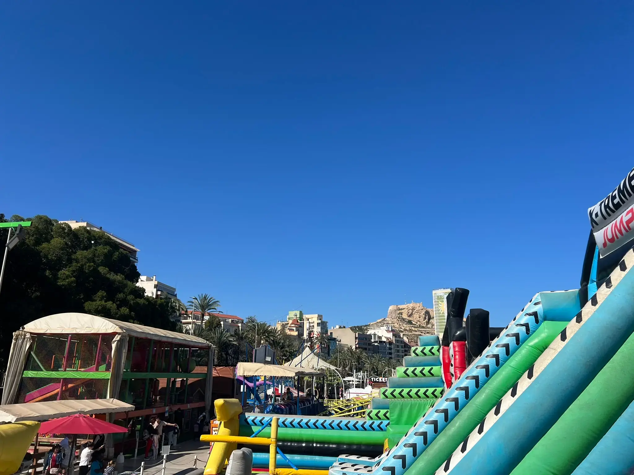 Alicante Marina amusement park with Santa Bárbara Castle on the hilltop in the background