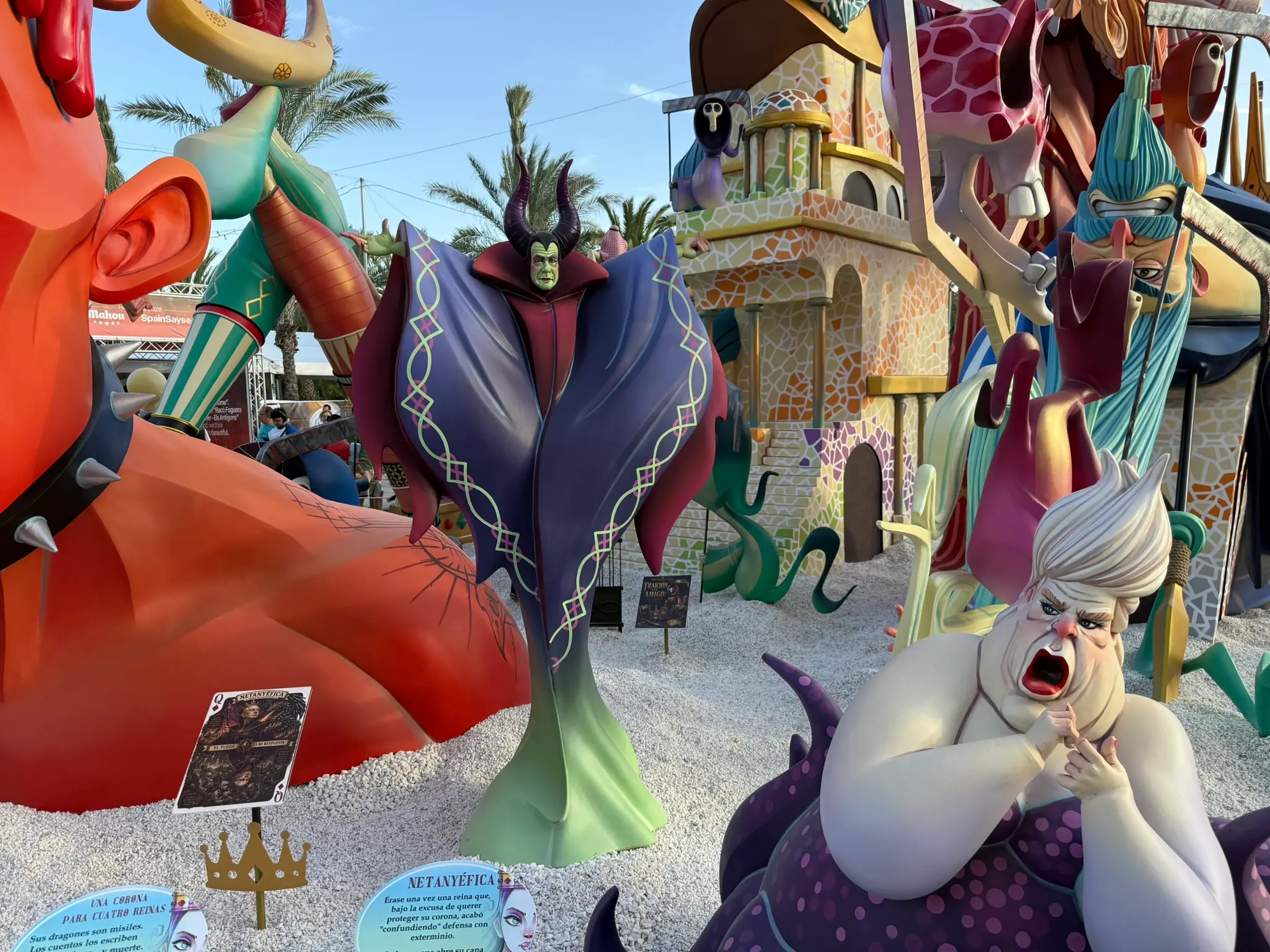 Detailed view of an official Hogueras monument featuring a large central figure of Maleficent surrounded by a mosaic building background and other unique effigies