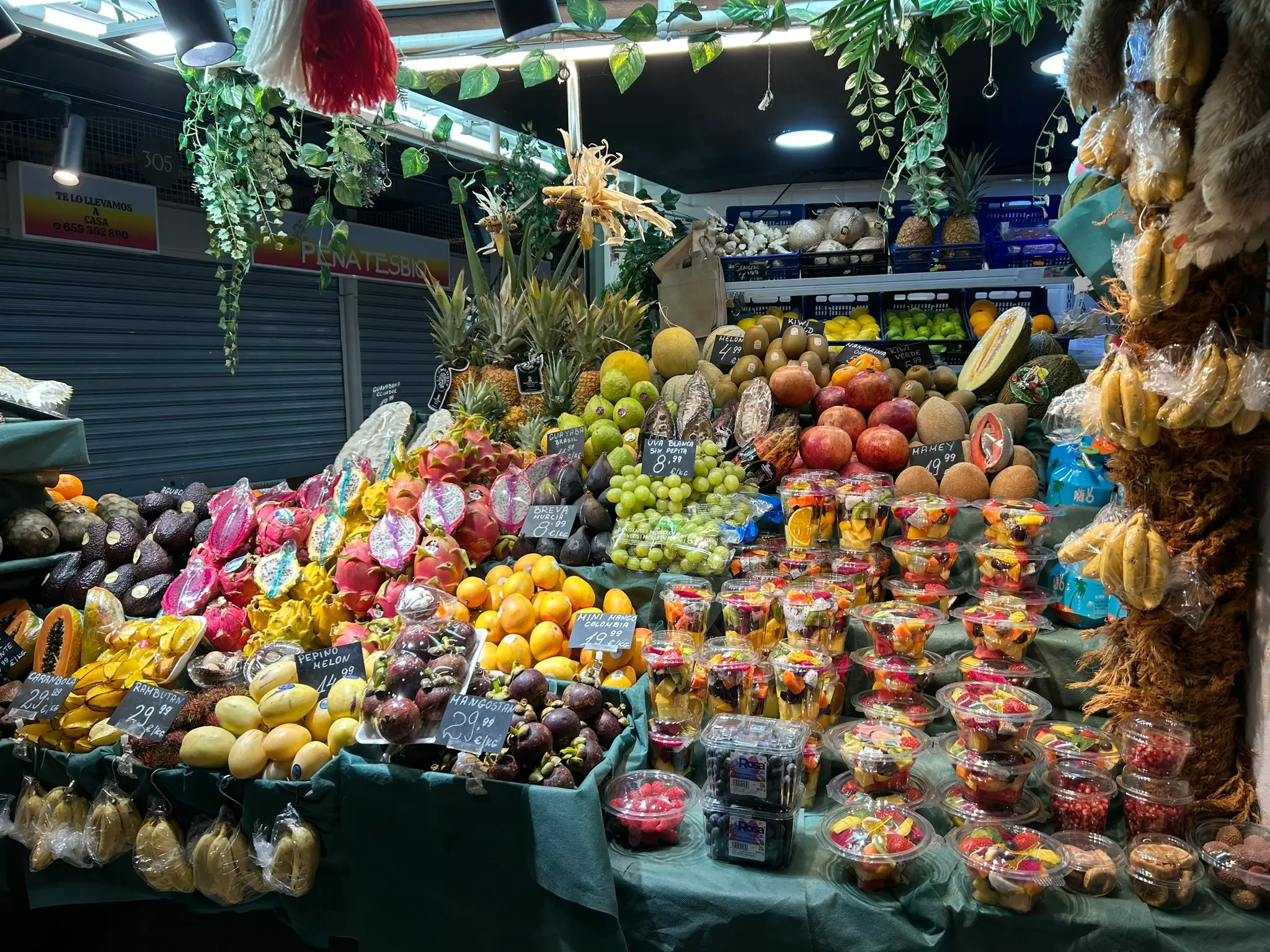 Tropical fruit stall with mangosteens, dragon fruit, mangoes