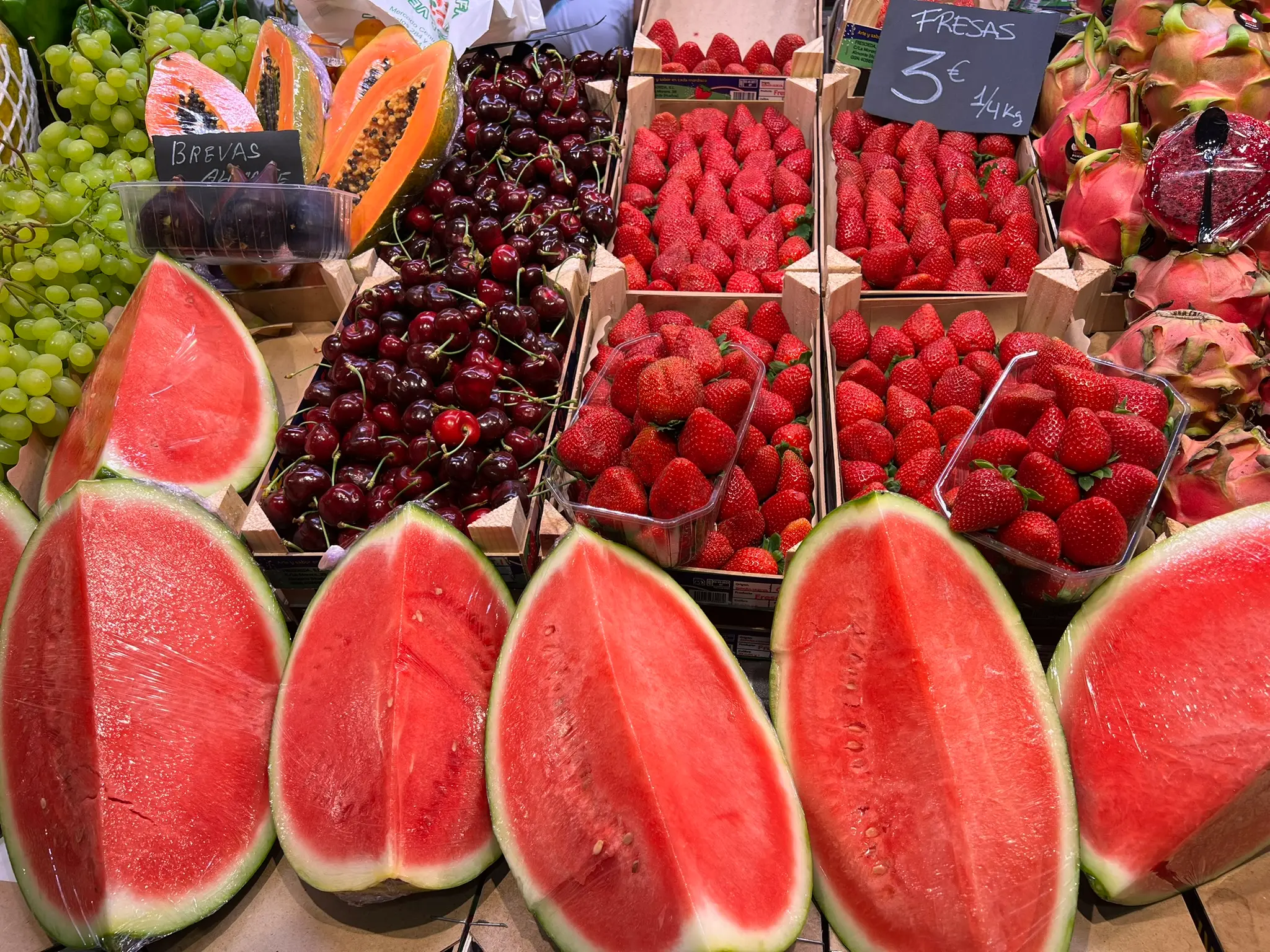 Fresh watermelons, strawberries, and brevas at Alicante's Mercado Central